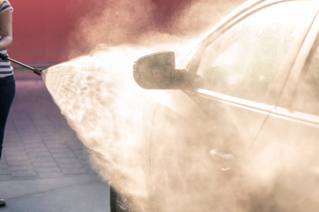 Woman washing a car at a car wash